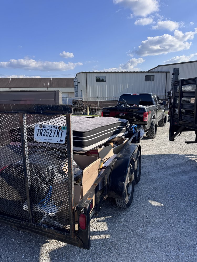 Junk removal hauling with pickup truck and loaded trailer for property maintenance Carmel, IN
